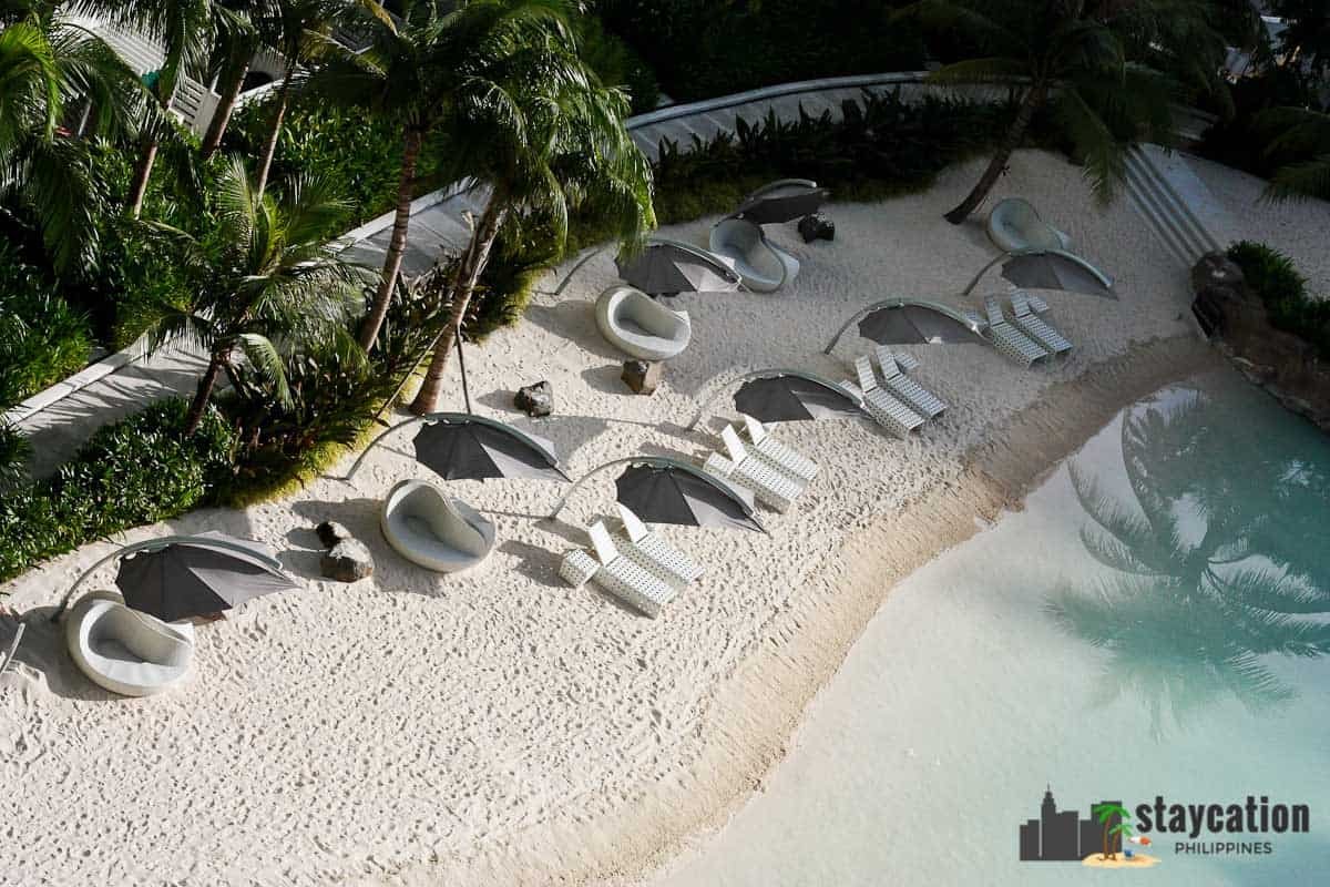 Azure white sand and posh beach chairs