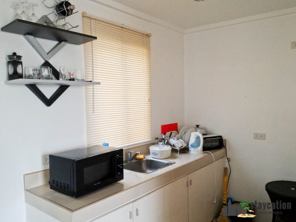 Kitchen with microwave and refrigerator